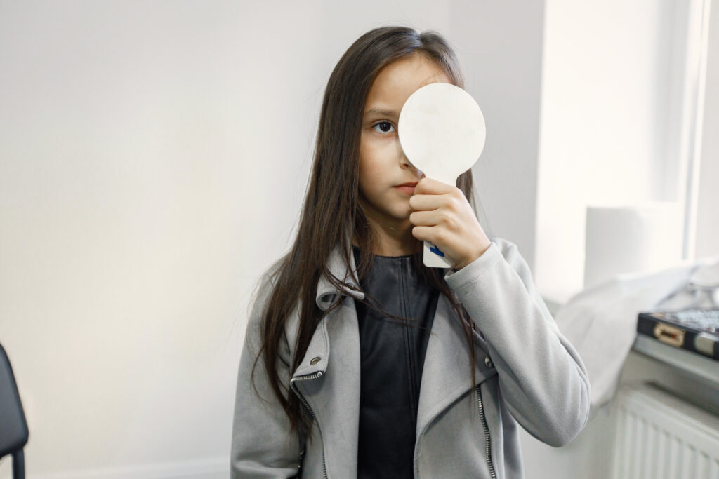 Girl Doing Eye Test Checking Examination At Ophthalmological Center
